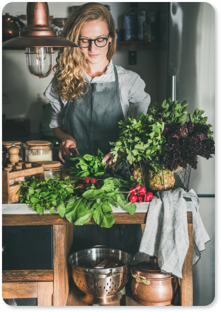 young-woman-cutting-herbs-and-vegetables